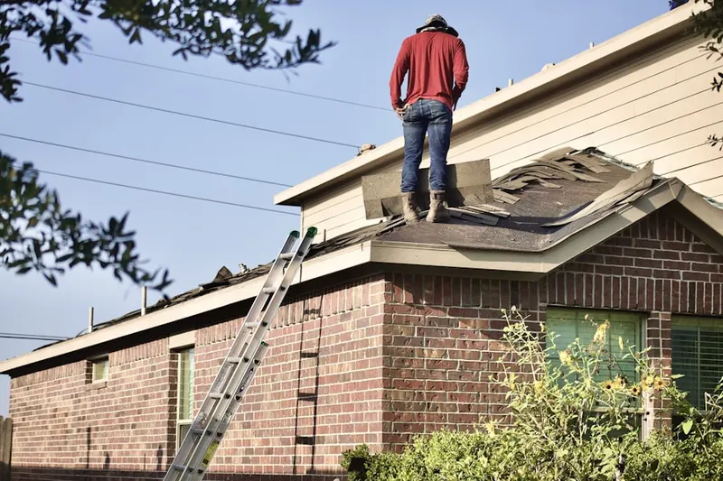 Professional roofer working on a residential roof in Friends View